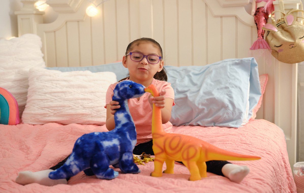 asley, child with sma playing with stuffed animals