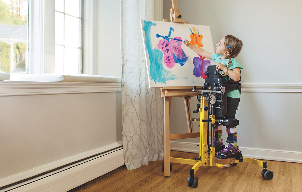 ruby, child with sma, painting on an easel