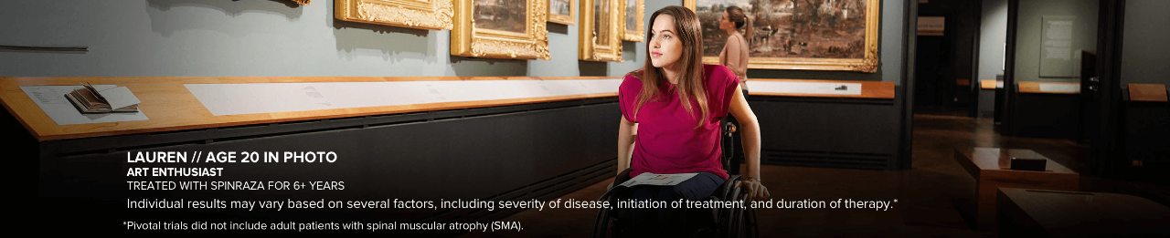 Lauren, age 20 in photo, looking at art in a museum. Has SMA and has been treated with SPINRAZA for 6+ years.