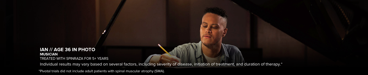 Ian, age 36 in photo, writing while sitting at a piano. Has SMA and has been treated with SPINRAZA for 5+ years.