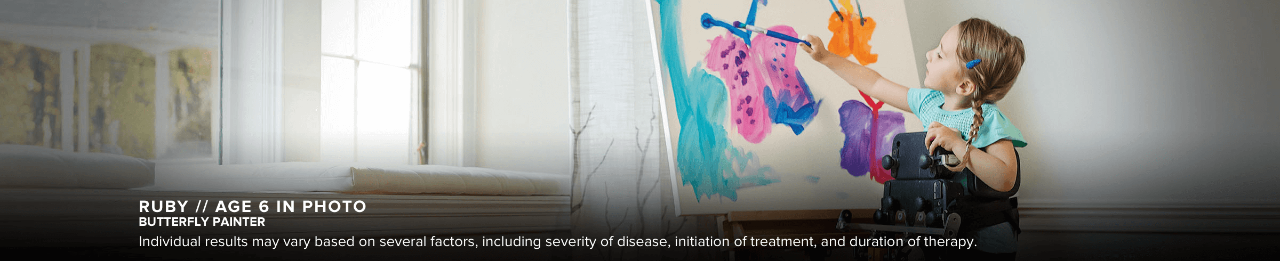 Ruby, age 6 in photo, has SMA and is pictured painting colorful butterflies on an easel.