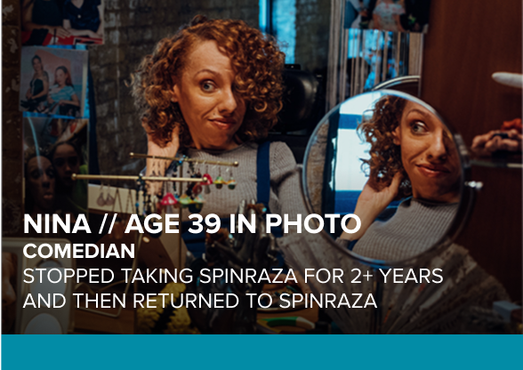 Nina, age 39 in photo, has SMA and is pictured looking in a mirror. Aspiring comedian treated with SPINRAZA for 5+ years.