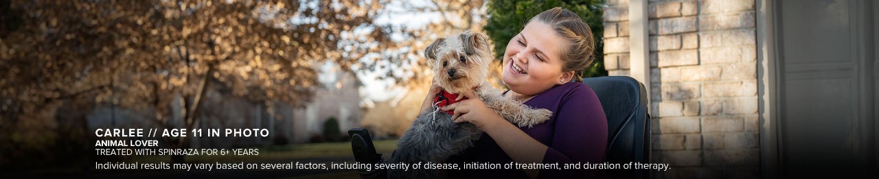 Carlee, age 11 in photo, playing with a dog outdoors. Has SMA and has been treated with SPINRAZA for 6+ years.