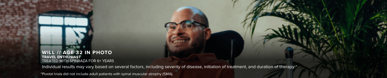 Will, age 32 in photo, sitting in a power chair. Has SMA and has been treated with SPINRAZA for 6+ years.